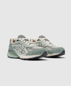 Men's New Balance 990v4 sneakers in green suede and mesh, side and front view
