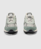 Pair of grey and mint green suede mesh sneakers with white laces, front view