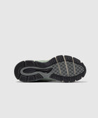 Close-up of New Balance sneaker sole with textured tread pattern on light background.