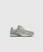 Light green and gray men's New Balance 990v4 sneaker in side view on white background