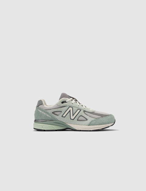 Light green and gray men's New Balance 990v4 sneaker in side view on white background