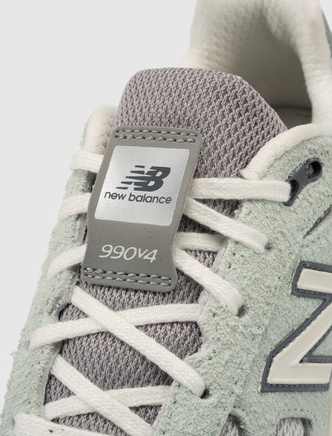 Close-up of New Balance 990v4 sneaker in grey mesh and suede with white laces
