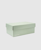 New Balance pastel green sneaker box on white background
