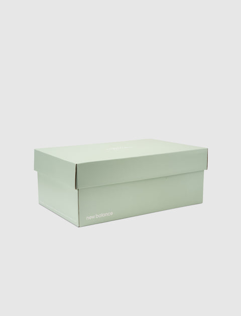 New Balance pastel green sneaker box on white background