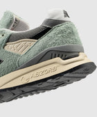 Close-up of textured green suede sneaker heel with ABZORB sole on light background