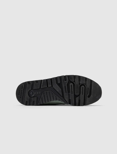 Black New Balance 998 sneaker outsole with textured tread pattern on white background