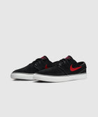 Black suede low-top sneakers with red swoosh and white sole on a plain background