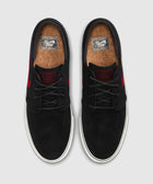 Black suede skate shoes with red accents, cork insoles, white rubber soles, top view