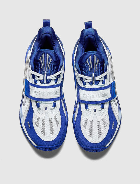 Top view of blue and white athletic sneakers with mesh panels and unique strap design