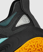 Close-up of black athletic sneaker with textured mesh, teal accents, and orange sole