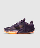 Purple low-top sneaker with mesh details, side fringe, and orange sole on plain background