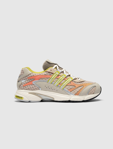 Beige mesh sneaker with yellow and coral accents, side view, chunky sole