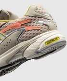 Beige and yellow mesh sneaker with adiprene sole and orange side detail, close-up view