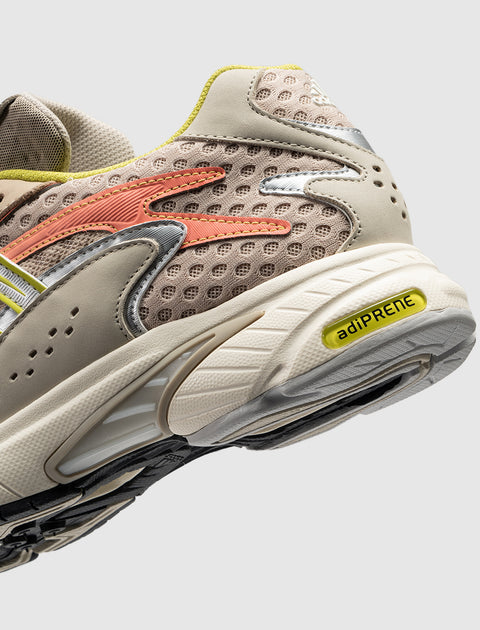 Beige and yellow mesh sneaker with adiprene sole and orange side detail, close-up view