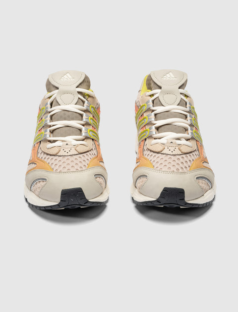 Beige and yellow mesh lace-up sneakers with Adidas logo, front view on white background