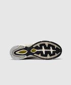 Outsole view of beige and black men's sneaker with textured rubber grip detailing