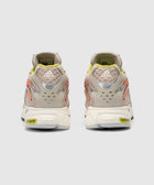 Back view of beige and yellow Adidas sneakers with mesh and Adiprene sole details