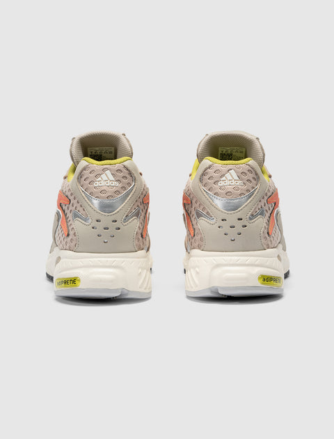 Back view of beige and yellow Adidas sneakers with mesh and Adiprene sole details
