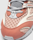 Close-up of pink mesh and suede sneaker with gray laces and white trim