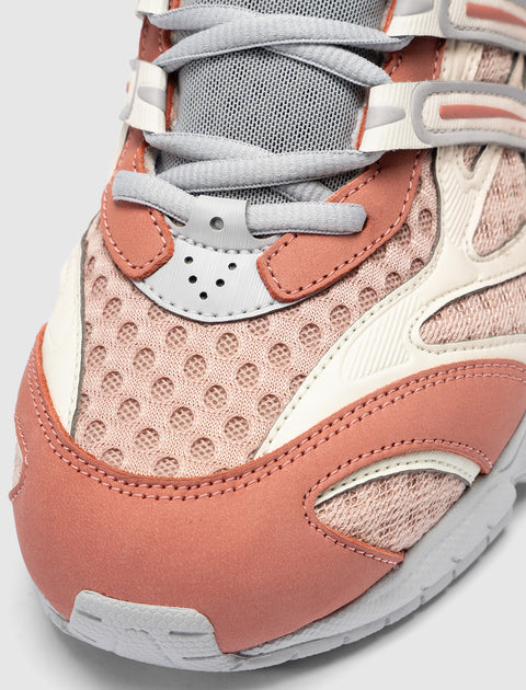Close-up of pink mesh and suede sneaker with gray laces and white trim