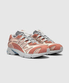 Pair of clay and beige mesh streetwear sneakers with grey accents on a white background