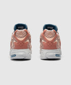 Rear view of pink and beige adidas sneakers with mesh details and white adiPRENE soles