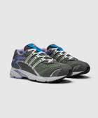 Gray mesh sneakers with green, blue, and purple accents on a white background.