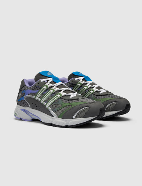 Gray mesh sneakers with green, blue, and purple accents on a white background.
