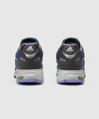 Rear view of gray and purple adidas sneakers with adiPRENE sole on a white background