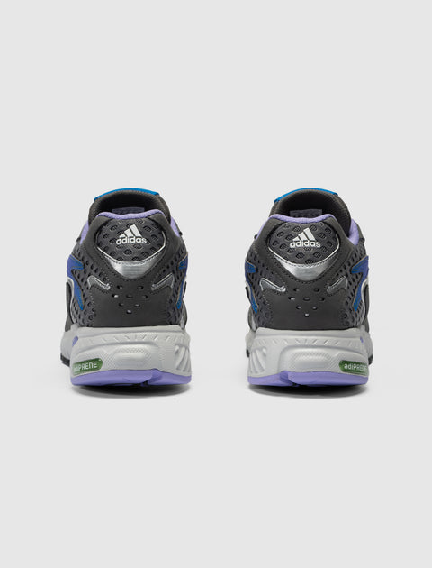 Rear view of gray and purple adidas sneakers with adiPRENE sole on a white background
