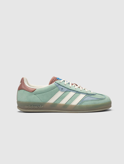 Green and blue suede sneaker with white stripes, brown heel tab, gum sole, side view on white background