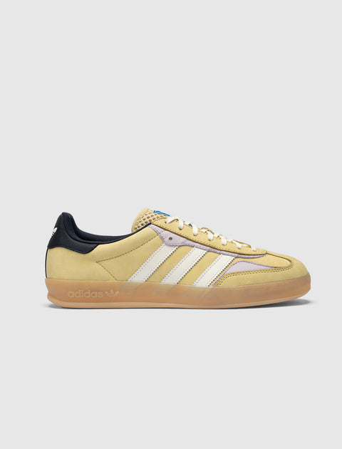 Yellow suede Adidas sneaker with white stripes, gum sole, and navy heel panel