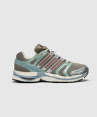 Brown and green mesh sneaker with silver accents and textured sole, side profile