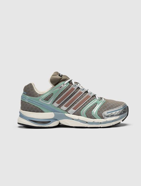 Brown and green mesh sneaker with silver accents and textured sole, side profile