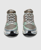 Pair of brown and mint green mesh sneakers with silver accents, viewed from the front
