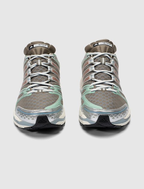 Pair of brown and mint green mesh sneakers with silver accents, viewed from the front