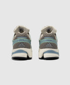 Rear view of gray and beige Adidas sneakers with blue accents and Formotion text on heel