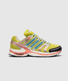 Yellow and orange athletic sneaker with mesh upper, silver and blue accents, side view