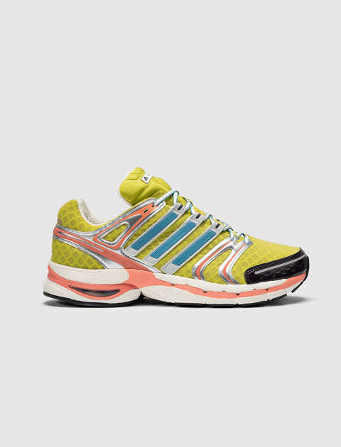 Yellow and orange athletic sneaker with mesh upper, silver and blue accents, side view