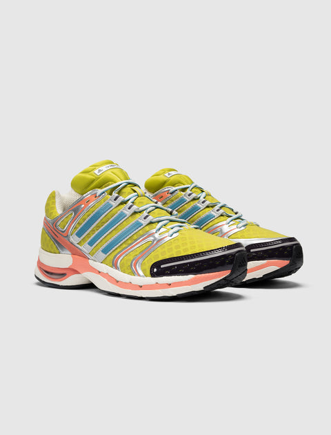 Yellow and blue mesh sneakers with silver accents and colorful sole on white background