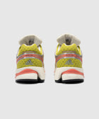 Rear view of yellow and coral Adidas sneakers with mesh upper and Formotion detail