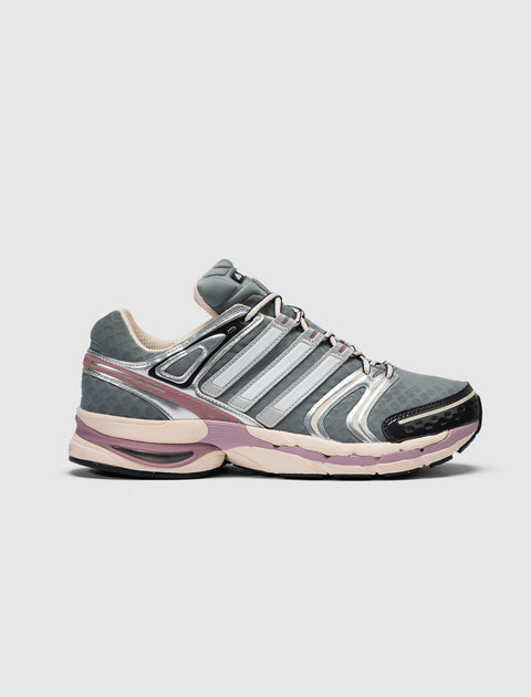 Gray and purple athletic sneaker with mesh and metallic accents, side view on white background