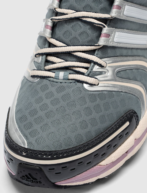Close-up of grey and purple mesh sneaker with beige laces and black toe detail