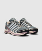 Gray and purple athletic sneakers with mesh upper, reflective accents, and lace-up design