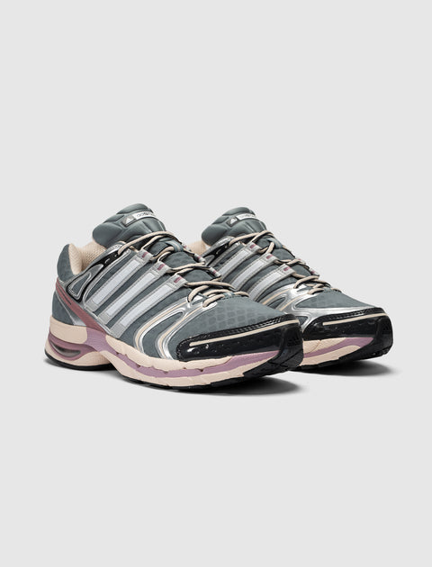 Gray and purple athletic sneakers with mesh upper, reflective accents, and lace-up design
