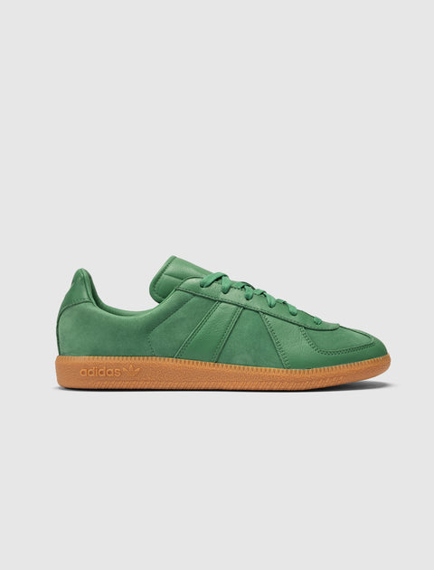 Green suede low-top sneaker with gum sole, adidas branding visible on the side