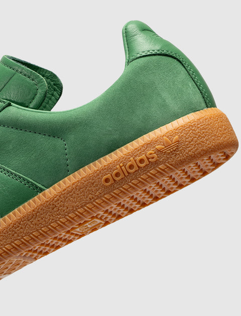 Close-up of green adidas sneaker with gum sole and embossed logo