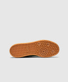 Gum rubber sole of a sneaker with geometric tread pattern, photographed against white background