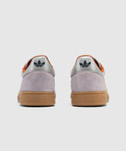 Back view of lilac suede sneakers with gum soles and silver heel tabs featuring trefoil logo