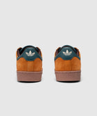 Back view of brown and teal suede sneakers with white Adidas trefoil logo on heel